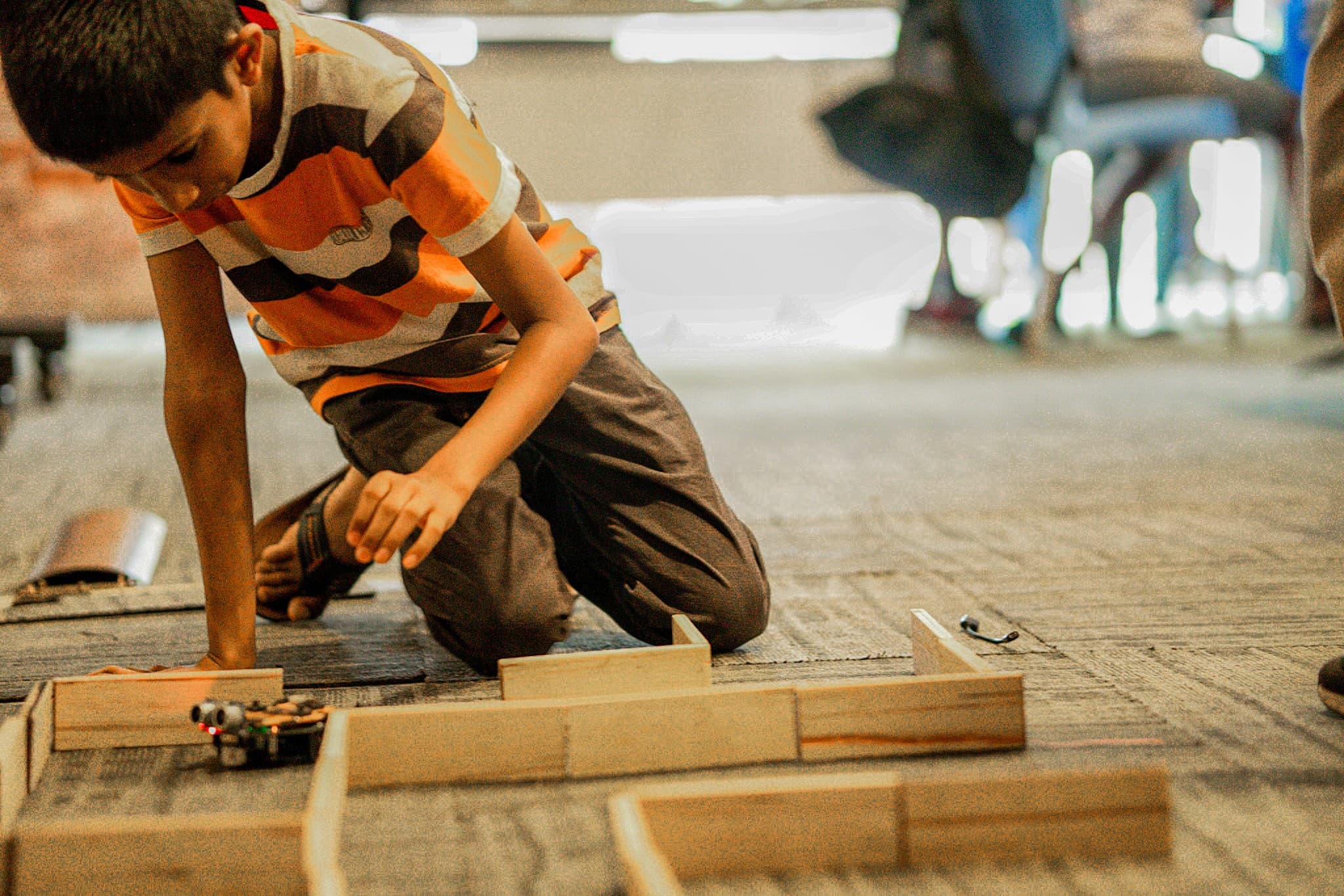 Kid with robot obstacle course